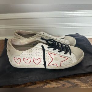Golden Goose sneakers with red heart stitching. Never worn.